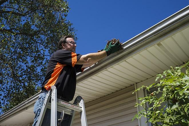 a man repairing a gutter on a residential home in Bayport